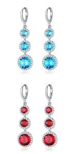 Detail of teardrop zircon drop earrings in vibrant blue and red gemstone colors
