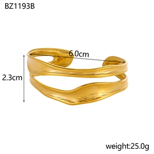 Detail view of wavy golden stainless steel cuff bracelet with 6.0cm diameter and 2.3cm height