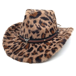 Close-up of leopard print cowboy hat featuring a leather band and silver bull head emblem