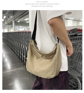 Detailed view of khaki large capacity nylon dumpling bag worn for a daily casual look