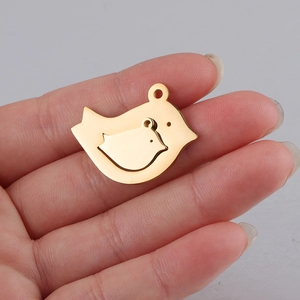 Close-up of golden stainless steel mother and baby bird pendant for DIY jewelry