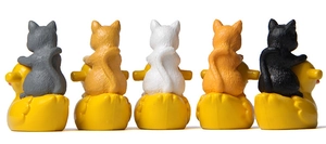 Rear view of five cute cat figurines riding yellow ducks for garden micro landscapes