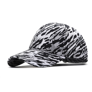 Baseball cap with black and white tiger stripe pattern and curved brim for sun protection