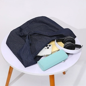 Internal view of large capacity dark blue denim tote bag showing daily essentials