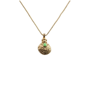 Elegant gold necklace with textured gourd pendant featuring a striking green gemstone center