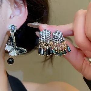 Silver needle earrings with zircon butterflies, pearls, and black tassel pendants