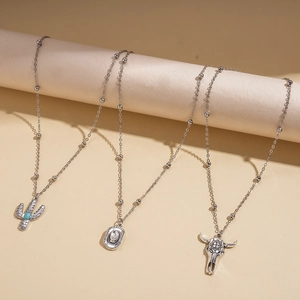 Western style silver necklace set featuring cactus cow skull and hat charms with turquoise