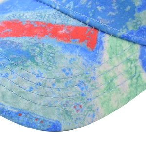 Macro view of colorful abstract graffiti print and precise stitching on cotton baseball cap
