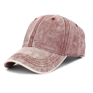 Detailed view of vintage washed burgundy cotton fabric and stitching on a baseball cap
