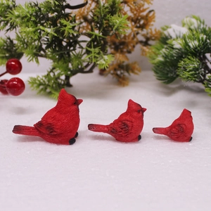 Three-piece set of red cardinal bird resin ornaments with realistic feather textures