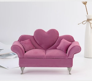 Detail view of the rose red velvet sofa jewelry box featuring a heart-shaped backrest