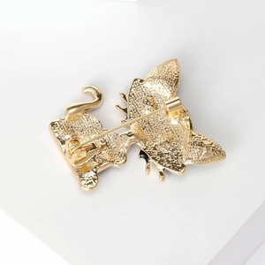 Back view of gold cat brooch with secure safety pin and textured alloy finish