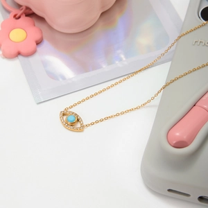 Gold Evil Eye pendant necklace with turquoise stone and sparkling zircon accents