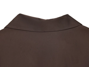 Detail view of the brown poplin shirt collar featuring intricate beadwork and texture