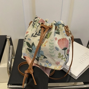 Vintage floral tapestry bucket bag with brown leather drawstring and golden hardware