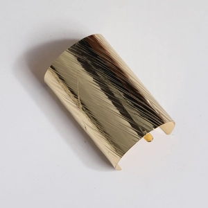 Detailed top view of gold minimalist hair hook with textured brushed metal finish
