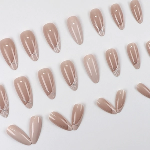 Elegant almond-shaped press-on nails with soft nude pink finish and silver glitter accents