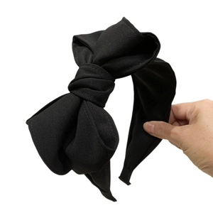 Elegant black multi-layer bow headband with pleated fabric detail on a wide frame