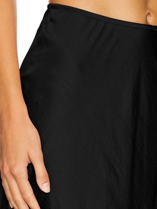 Close-up of black satin skirt showing smooth silk-like texture and high-waist side seam detail