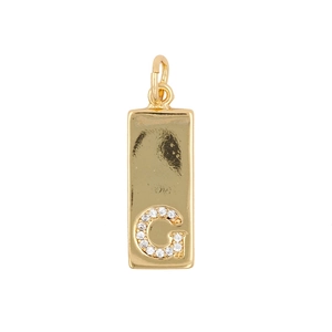 Detailed close-up of a golden rectangular pendant featuring a sparkling micro-set letter G