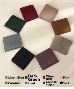 Top view of eight slim leather wallets in various colors with minimalist stitching detail