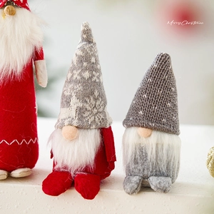 Three-piece set of red and grey Scandinavian Christmas gnomes for festive tabletop decor