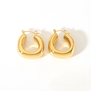 Close-up of polished 18K gold-plated U-shaped earrings with a smooth metallic finish