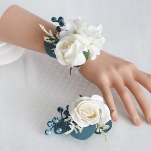 Wedding boutonniere and wrist corsage set featuring white silk roses and blue berries