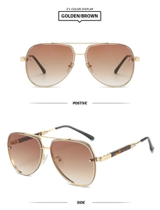 Detail view of gold metal pilot sunglasses with brown gradient lenses and tortoise tips