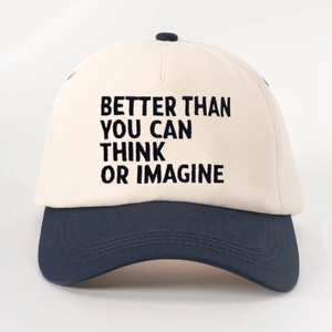 Two-tone baseball cap in cream and navy blue with BETTER THAN embroidery on light background