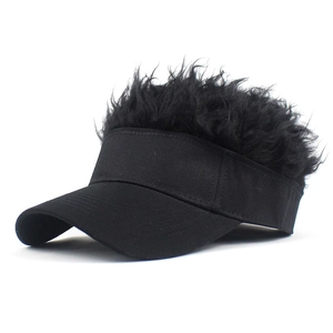 Detail of creative visor hat featuring a black brim and unique fluffy synthetic hair top