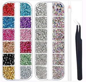 Detailed set of mixed size acrylic nail rhinestones with tweezers and picking pen