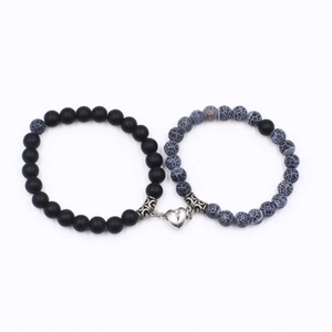 Matching couple bracelets with matte black beads and turquoise with a heart magnet clasp