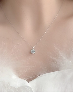 Close-up of S925 sterling silver X-shape necklace with sparkling moissanite solitaire