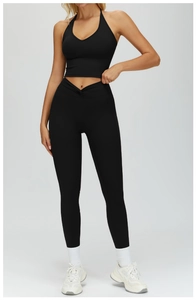 Detail of high waist yoga leggings featuring a unique V-shaped crossed twist waistband design