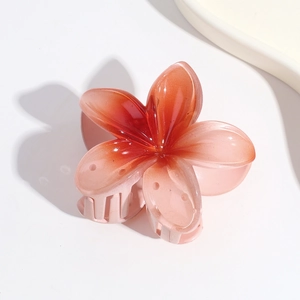Detailed view of Y2K gradient pink flower hair claw clip with glossy acrylic finish