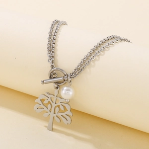 Close-up of silver tree of life pendant with pearl and OT toggle on layered steel chain