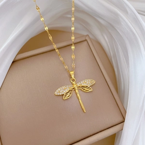 Gold dragonfly necklace with sparkling crystal wings displayed on a premium jewelry gift box