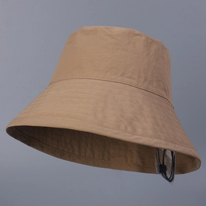 Detail of khaki sun hat featuring a wide brim and adjustable drawstring with wind buckle
