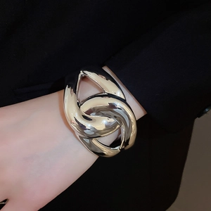 Polished silver cross acrylic bangle featuring a wide geometric layered hollow design
