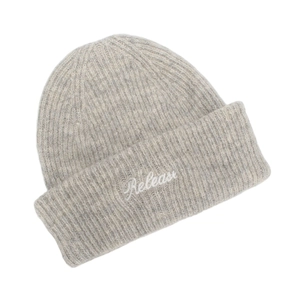 Close-up of light gray ribbed knit beanie featuring white Releas embroidery detail