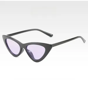 Detail of cat eye sunglasses with glossy black frames and purple tinted lenses
