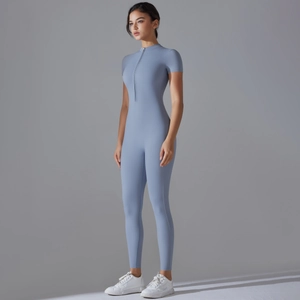 Side view detail of a light blue zip-front yoga jumpsuit with high-stretch fabric and short sleeves