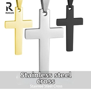 Close-up of three polished stainless steel cross pendants in gold, silver, and black