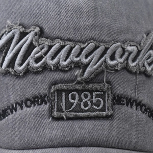 Close-up of vintage grey washed cotton baseball cap with New York 1985 embroidery details