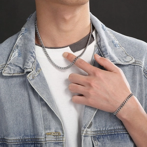 Men's silver titanium steel Cuban link chain necklace and bracelet jewelry set on model