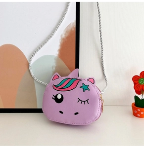 Close-up of a purple unicorn crossbody purse for girls with a shiny silver braided strap