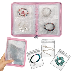 Pink jewelry organizer book with transparent PVC loose-leaf pockets and zipper closure