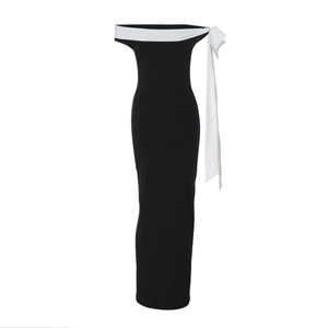 Detailed close-up of the elegant black and white off-shoulder dress with bow ribbon detail