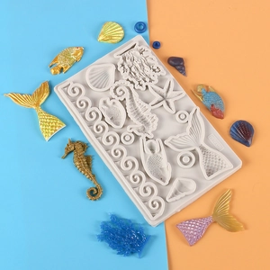 Detailed silicone mold featuring mermaid tails, seashells, and starfish for cake decorating